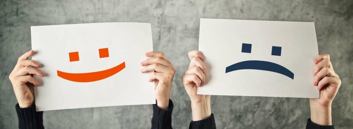 Happy,And,Sad,Face,Emoticons,,Two,Women,Holding,Papers,With Happy,And,Sad,Face,Emoticons,,Two,Women,Holding,Papers,With