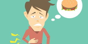 韓国を訪れた際、胃の痛みと胃の中にハンバーガーを抱えた男性。 韓国を訪れた際、胃の痛みと胃の中にハンバーガーを抱えた男性。