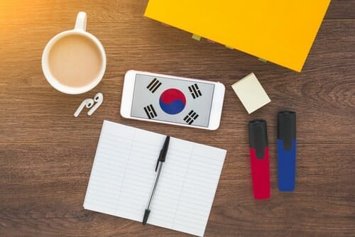 Smartphone,With,Korean,Flag,On,A,Wooden,Dark,Background,,Textbook,