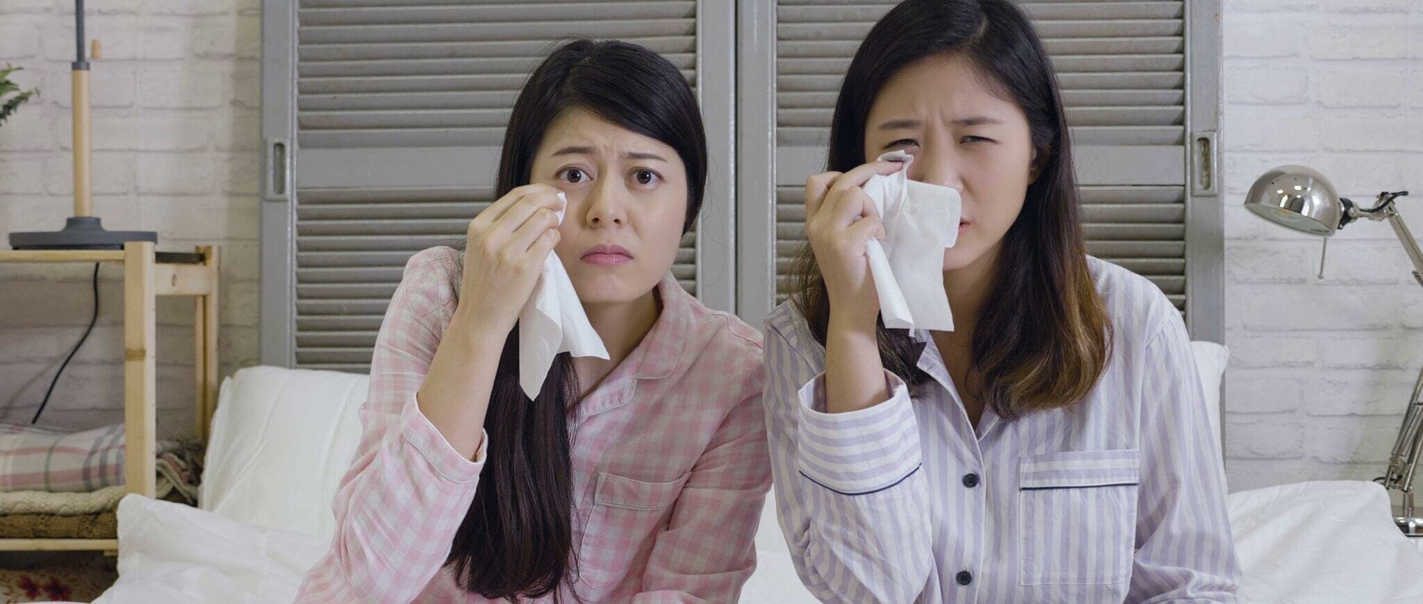 韓国で泣きながら涙を拭う二人の女性。
