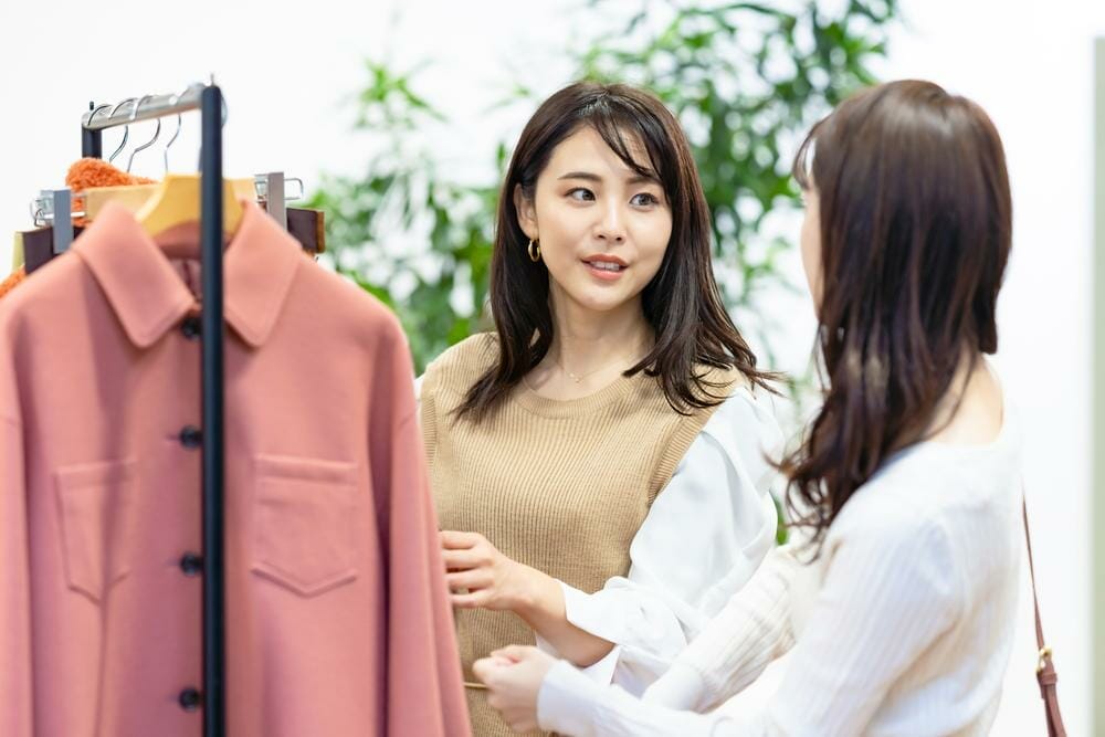 ラックの上の服を見ている 2 人の韓国人女性。 ラックの上の服を見ている 2 人の韓国人女性。
